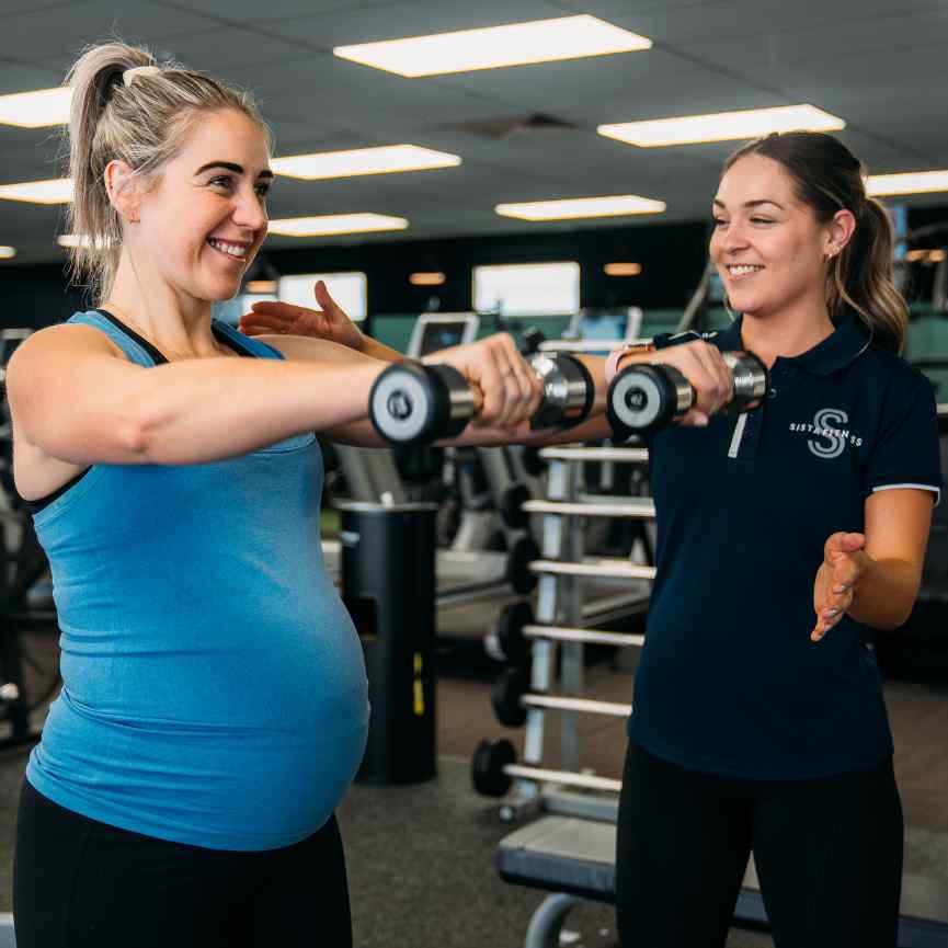 Pregnant woman using dumbbell